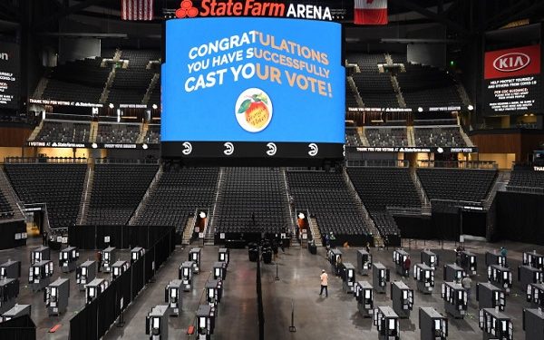 epaselect epa08739286 State Farm Arena is used as a polling place on the first day of early voting in the US Presidential election, shown underway in Atlanta, Georgia, USA, 12 October 2020.  EPA/JOHN AMIS