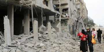 Wreckage of collapsed buildings are seen after the Assad Regime carried out air strikes in Eastern Ghouta, Syria [Samir Tatin / Anadolu Agency]