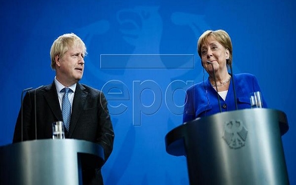 epa07784831 British Prime Minister Boris Johnson (L) and German Chancellor Angela Merkel give a joint press statement at the Chancellery in Berlin, Germany, 21 August 2019. Prior to the G7 summit in Biarritz form 24 to 27 August 2019, Johnson meets Angela Merkel and on the next day French President Emmanuel Macron. In the talks, Johnson is expected to try to resume the Brexit talks, so that it will not come to a 'no deal' exit of the United Kingdom from the EU on 31 October 2019.  EPA-EFE/CLEMENS BILAN