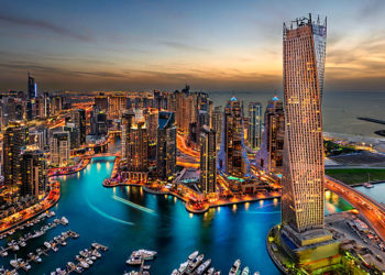 Dubai Marina from a high view showing the boats, sea, and the city scape.