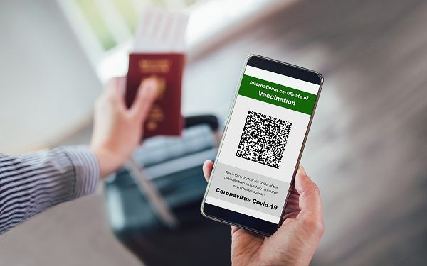 Vaccination, disease immunity passport, health and surveillance concepts. Smartphone displaying a valid digital vaccination certificate for COVID-19