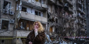 Natali Sevriukova reacts next to her house following a rocket attack the city of Kyiv, Ukraine, Friday, Feb. 25, 2022. (AP Photo/Emilio Morenatti)