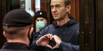 Рускиот опозициски лидер, Алексеј Навални, прави симбол на срцето упатен кон неговата сопруга во судницата во Москва во февруари, 2021, каде што доби казна затвор од над 2 и пол години. Оттогаш, тој исчезнува во рускиот казнен систем. (Фото:  Moscow City Court via AP)