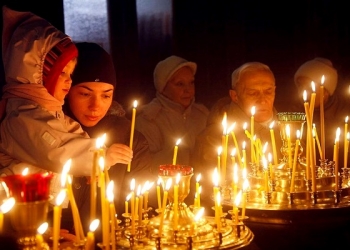 People light candles in a church  to mark the Orthodox Christmas in Kiev, Ukraine, Friday, Jan. 7, 2011.  Christmas falls on Jan. 7 for Orthodox Christians in the Holy Land, Ukraine and other Orthodox churches that use the old Julian calendar instead of the 16th-century Gregorian calendar adopted by Catholics and Protestants and commonly used in secular life around the world.(AP Photo/Efrem Lukatsky)