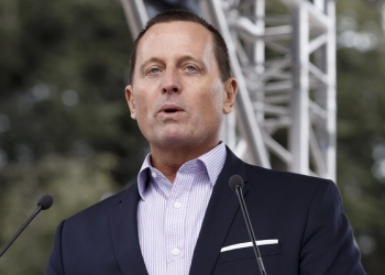 epa07446895 U.S. Ambassador to Germany Richard Grenell waits before speaking to people which protest anti-Israeli bias during the 'Rally for Equal Rights at the United Nations' at Place des Nations in front of the European headquarters of the United Nations in Geneva, Switzerland, 18 March 2019.  EPA-EFE/SALVATORE DI NOLFI