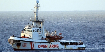epaselect epa07774325 A view of Spanish humanitarian ship Open Arms, with 147 migrants on board, in the immediate vicinity of Lampedusa, southern Italy, 15 August 2019. Several patrol boats of the Italian finance guard and the harbor master's office are monitoring the movements of the Spanish NGO boat that headed towards the island of Pelagie, escorted by two military ships, after the Lazio Regional Administrative Court accepted its appeal, suspending the ban on entry into Italian waters ordered by Italian Interior Minister Matteo Salvini.  EPA-EFE/ELIO DESIDERIO