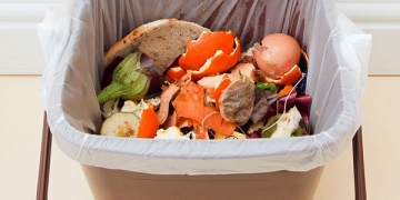BK9BDX UK. Food waste in indoor food waste bin with lid open indoors