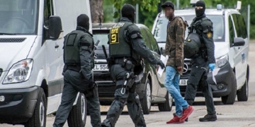 epa06708023 Special forces of German police arrest a man at the initial reception center for refugees in Ellwangen, Germany, 03 May 2018. On the night of April 30, the police arrested a 23-year-old resident from Togo for a deportation order at the state reception center. Some 50 residents attacked the police to force the release of the arrested man. Since early morning of 03 May, the police have been in large-scale deployment on the grounds to arrest several suspects involved in the 30 April attack on the security forces.  EPA-EFE/KOHLS/SDMG ATTENTION EDITORS: FACE PIXELATED DUE TO GREMAN LAW