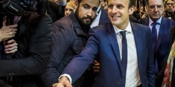epa06907398 The then French presidential candidate Emmanuel Macron (C-R) of the 'En Marche' political movement flanked by security staff Alexandre Benalla (C-L) visiting the International Agriculture Fair in Paris, France, 01 March 2017 (reissued 24 July 2018).  A video has been released on 19 July 2018, allegedly showing Alexandre Benalla, French President Emmanuel Macron's deputy chief of staff, wearing a riot helmet and police uniform, while attacking protesters during street demonstrations on 01 May 2018. Media reports on 24 July state that Benalla has been fired and the prosecution is officially investigating the case.  EPA-EFE/CHRISTOPHE PETIT TESSON