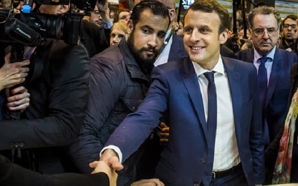 epa06907398 The then French presidential candidate Emmanuel Macron (C-R) of the 'En Marche' political movement flanked by security staff Alexandre Benalla (C-L) visiting the International Agriculture Fair in Paris, France, 01 March 2017 (reissued 24 July 2018).  A video has been released on 19 July 2018, allegedly showing Alexandre Benalla, French President Emmanuel Macron's deputy chief of staff, wearing a riot helmet and police uniform, while attacking protesters during street demonstrations on 01 May 2018. Media reports on 24 July state that Benalla has been fired and the prosecution is officially investigating the case.  EPA-EFE/CHRISTOPHE PETIT TESSON