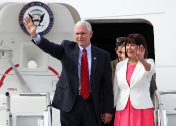 US Vice President Mike Pence and his wife Karen Pence wave as they arrive at the US Osan Air Base in Pyeongtaeck on April 16, 2017.
Pence arrived in South Korea for a three-days visit where the nuclear issue will be top of the agenda at talks with South Korea's acting president Hwang Kyo-Ahn. / AFP PHOTO / YONHAP / STR /  - South Korea OUT / REPUBLIC OF KOREA OUT  NO ARCHIVES  RESTRICTED TO SUBSCRIPTION USE