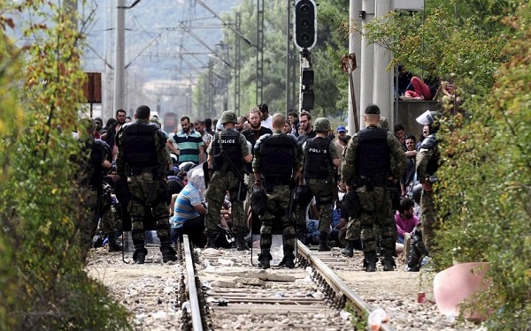 Macedonian special policemen guard the border as more than a thousand immigrants wait at the border line of Macedonia and Greece to enter Macedonia near the Gevgelija railway station August 21, 2015.  REUTERS/Ognen Teofilovski