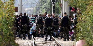Macedonian special policemen guard the border as more than a thousand immigrants wait at the border line of Macedonia and Greece to enter Macedonia near the Gevgelija railway station August 21, 2015.  REUTERS/Ognen Teofilovski