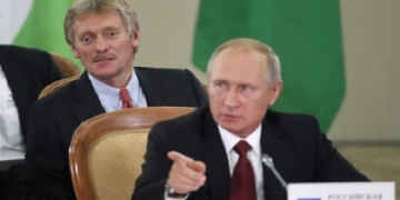 epa06259003 Russian President Vladimir Putin (front) and Kremlin spokesman Dmitry Peskov (back) attend a session of the Council of Heads of the Commonwealth of Independent States (CIS) in the Black sea resort of Sochi, Russia, 11 October 2017. CIS leaders meet in Sochi to discuss cooperation within the Commonwealth.  EPA-EFE/MAXIM SHEMETOV / POOL