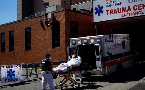 Paramedics wheel a patient from an ambulance to an emergency arrival area at Elmhurst Hospital during the outbreak of the coronavirus disease (COVID-19) in the Queens borough of New York City, New York, U.S., April 6, 2020. REUTERS/Eduardo Munoz