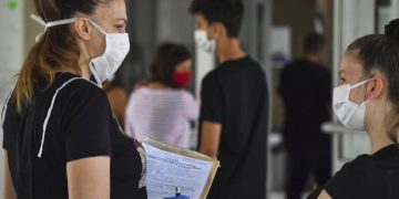 epa08488151 High-school students wear protective face masks as they wait in line to register for the upcoming school year in Skopje, North Macedonia, 16 June 2020. All schools in the country have been closed over the past three months due to the ongoing pandemic of COVID-19 disease caused by the SARS-CoV-2 coronavirus, prompting the suspension of the current school year.  EPA-EFE/GEORGI LICOVSKI