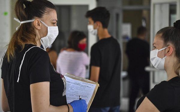 epa08488151 High-school students wear protective face masks as they wait in line to register for the upcoming school year in Skopje, North Macedonia, 16 June 2020. All schools in the country have been closed over the past three months due to the ongoing pandemic of COVID-19 disease caused by the SARS-CoV-2 coronavirus, prompting the suspension of the current school year.  EPA-EFE/GEORGI LICOVSKI