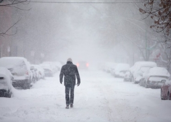 CHICAGO, IL - FEBRUARY 01:  A man walks down a snow-covered street on February 1, 2015 in Chicago, Illinois. Fifteen inches or more of snow is expected to fall on the city before Monday morning. The snow has caused power outages and forced about 2,000 flight cancelations at the city's airports. (Photo by Scott Olson/Getty Images)