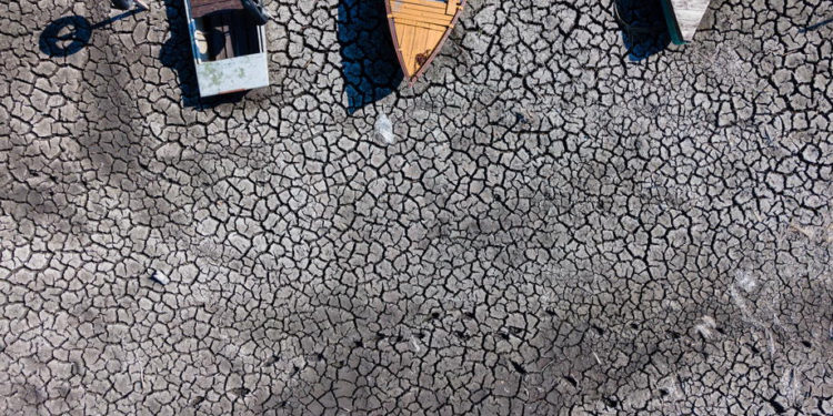 epa10126347 A photo taken with a drone shows boats sitting in the dried bed of Lake Velencei,  in Velence, Hungary, 17 August 2022. Due to the lasting unusual heat and drought, the water level of the lake stands at 55 centimeters, eight centimeters below the ever measured lowest level of 63 centimetres.  EPA-EFE/Tamas Vasvari HUNGARY OUT