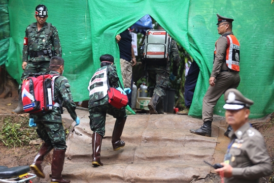 epa06874660 A handout photo made available by the Chiang Rai Public Relations Office shows Thai military medical personnel walking inside a restricted area as preparations are made to transport rescued boys from Tham Luang cave to a hospital, in Khun Nam Nang Non Forest Park, Chiang Rai province, Thailand, 08 July 2018 (issued 09 July 2018). According to reports, four boys were rescued on 08 July 2018. Rescue operations continue for the remaining members of a youth soccer team, including their assistant coach, who have been trapped in Tham Luang cave since 23 June 2018.  EPA-EFE/CHIANG RAI PR OFFICE / HANDOUT HANDOUT HANDOUT EDITORIAL USE ONLY/NO SALES HANDOUT EDITORIAL USE ONLY/NO SALES