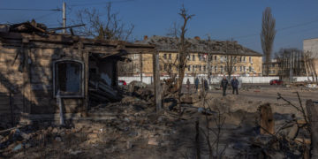 epa09839496 People walk past the severely damaged area after the Russian shelling, in Zhytomyr city, north-west Ukraine, 20 March 2022. The maternity hospital in Zhytomyr was damaged by a Russian missile strike a few weeks ago. Russian troops entered Ukraine on 24 February resulting in fighting and destruction in the country, and triggering a series of severe economic sanctions on Russia by Western countries.  EPA-EFE/ROMAN PILIPEY