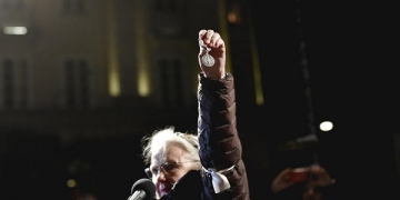 epa08060515 Swedish physician Christina Doctare holds a medal she received while working for the UN peacekeeping forces in Bosnia in the 1990s, during a protest against the awarding of the 2019 Nobel literature prize to Peter Handke, in Stockholm, Sweden, 10 December 2019.  EPA-EFE/Stina Stjernkvist  SWEDEN OUT
