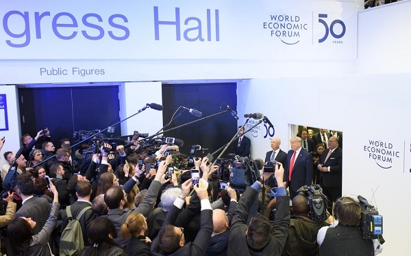 epa08146929 US President Donald J. Trump (R, red tie) speaks to the media next to German Klaus Schwab (2-R), Founder and Executive Chairman of the World Economic Forum, before addressing a plenary session during the 50th annual meeting of the World Economic Forum (WEF) in Davos, Switzerland, 21 January 2020. The meeting brings together entrepreneurs, scientists, corporate and political leaders in Davos under the topic 'Stakeholders for a Cohesive and Sustainable World' from 21 to 24 January 2020.  EPA-EFE/ALESSANDRO DELLA VALLE