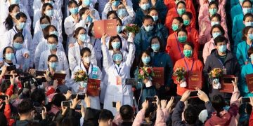 epa08285089 Medical staff celebrate after all patients were discharged at Wuchang Fangcang hospital, a temporary hospital set up at Hongshan gymnasium to treat people infected with the coronavirus and COVID-19 disease, in Wuhan, Hubei Province, China, 10 March 2020 (issued 11 March 2020). The temporary hospital closes on 10 March after China reported days of decline in the number of new coronavirus cases originating in the country. However, the number of coronavirus cases imported to China continued to rise, with 40 percent of the latest 24 infections reported on 11 March stemming from overseas.  EPA-EFE/YFC CHINA OUT