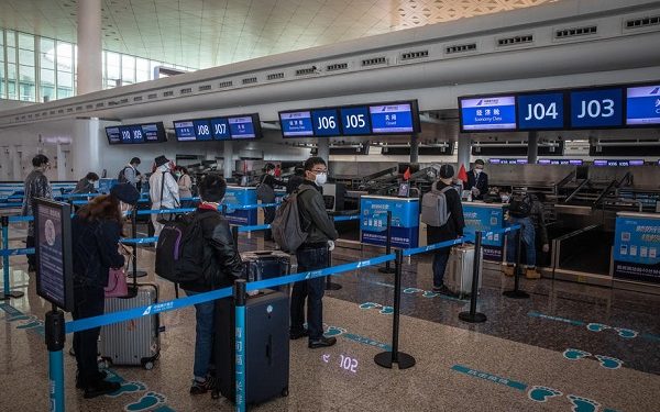 epa08349893 Passengers in protective gears wait at Wuhan Tianhe International Airport after the lockdown was lifted in Wuhan, China, 08 April 2020. Wuhan, the epicenter of the coronavirus outbreak, lifted the lockdown on 08 April 2020, allowing people to leave the city after more than two months. According to Chinese government figures, over 2,500 people have died of Covid-19 in Wuhan since the outbreak began.  EPA-EFE/ROMAN PILIPEY