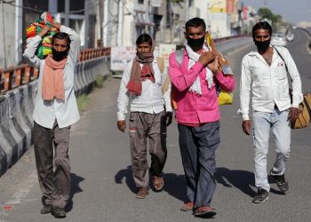 epa08407794 Migrant workers from Uttar Pradesh state on their way back from Railway station with their belongings as they arrived before their assigned travelling date by train, amid the ongoing COVID-19 coronavirus emergency lockdown in Amritsar, India, 07 May 2020. A. According to news reports, a total of 1188 migrant workers left for Gonda in Uttar Pradesh from Amritsar on a special train on 07 May 2020. The Indian government and Indian Railways have partially resumed passenger train service to evacuate stranded migrants, students, pilgrims and tourists to Bihar, Madhya Pradesh, Uttar Pradesh, Jharkhand and Odisha. Passengers arriving on these trains are quarantined for 14 days and monitored by the local health authorities.  EPA-EFE/RAMINDER PAL SINGH