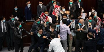 epa08409347 Pro-democracy and pro-Beijing lawmakers scuffle during a House Committee at the Legislative Council in Hong Kong, China, 08 May 2020. Several pro-democracy legislators were dragged out of the chamber by security guards as the pro-democracy and the pro-Beijing camps scuffled for control of the House Committee which has been gridlocked for months. The House Committee is responsible for scrutinising bills before sending them for a final vote.  EPA-EFE/JEROME FAVRE
