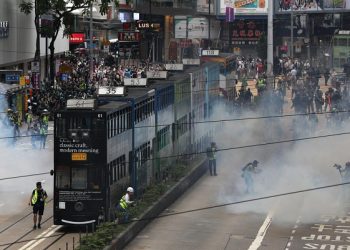 epa08440582 Police fire tear gas to disperse protesters during a rally against the implementation of a new national security law in Causeway Bay, Hong Kong, China, 24 May 2020. Beijing unveiled a resolution at the opening of its annual legislative sessions that will bypass Hong Kong's legislature to outlaw acts of secession, subversion and terrorism in Hong Kong.  EPA-EFE/JEROME FAVRE