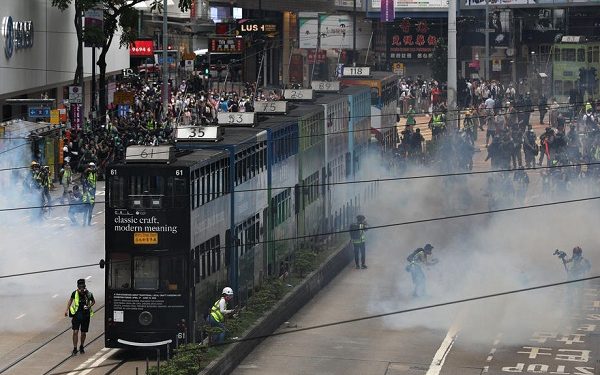 epa08440582 Police fire tear gas to disperse protesters during a rally against the implementation of a new national security law in Causeway Bay, Hong Kong, China, 24 May 2020. Beijing unveiled a resolution at the opening of its annual legislative sessions that will bypass Hong Kong's legislature to outlaw acts of secession, subversion and terrorism in Hong Kong.  EPA-EFE/JEROME FAVRE