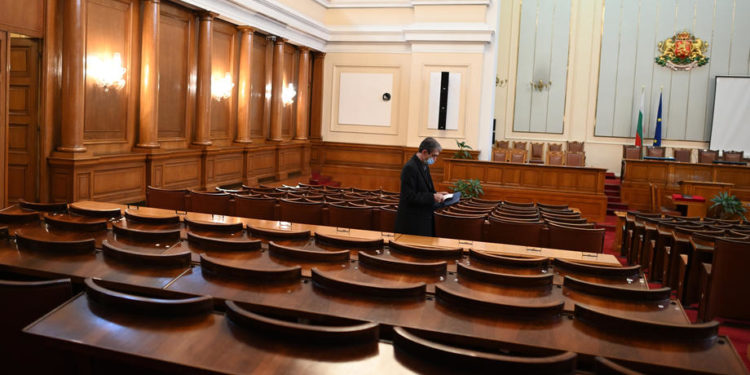 epa09136453 A deputy enters the plenary hall before the first session of newly elected Parliament in Sofia, Bulgaria, 15 April 2021. The Bulgarian Parliament, which emerged from the 04 April elections, has been constituted with six parties, no easy combination of majorities and a prospect of new elections that was recognized even by the country's president, Rumen Radev.  EPA-EFE/VASSIL DONEV