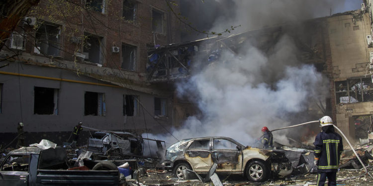 epa09893660 Ukrainian firefighters work at a damaged residential area following a Russian shelling in Kharkiv, Ukraine, 16 April 2022. Kharkiv, Ukraine's second-largest city, and its surroundings have been heavily shelled by Russian forces since the invasion began on 24 February 2022.  EPA-EFE/SERGEY KOZLOV